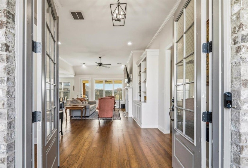Foyer entrance featuring french doors, dark wood-style floors, ornamental molding, recessed lighting, and a ceiling fan