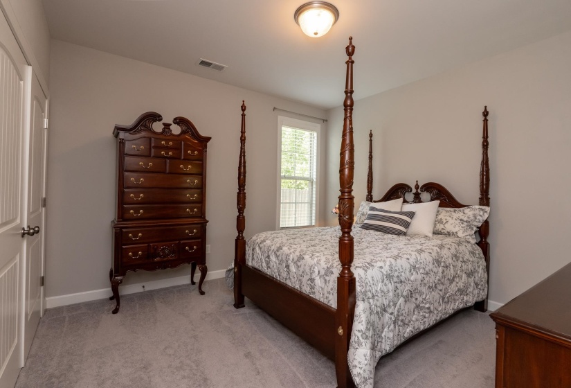Bedroom with light gray wall paint and matching gray carpet flooring