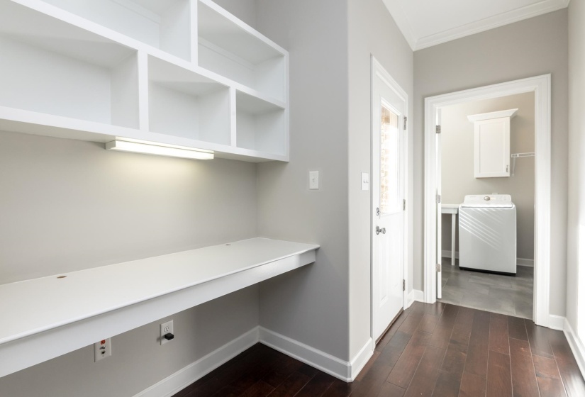 Built-in desk with integrated lighting and overhead shelving