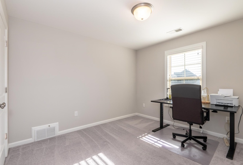 Room with neutral gray wall paint, light gray carpet flooring, and a white trim window with blinds