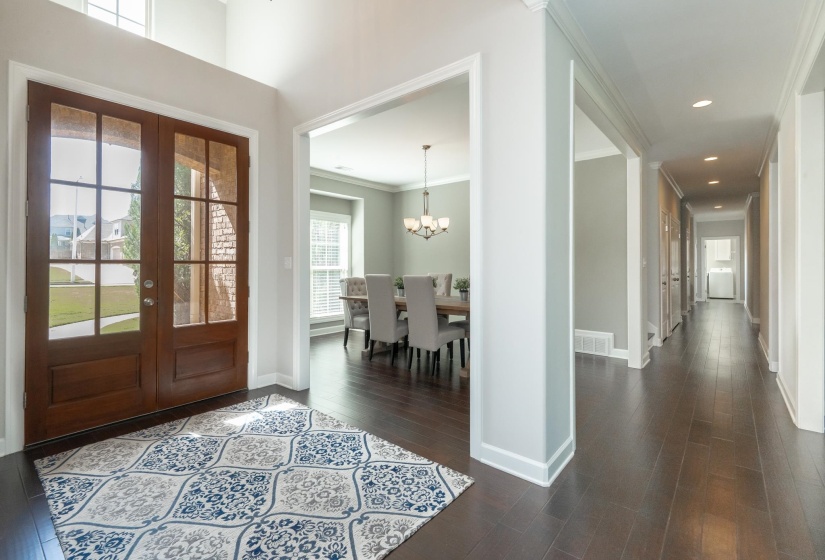 Double-door entry with transom window and wood-finish flooring