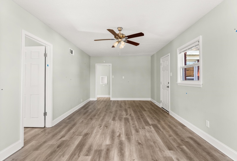 Spare room with light wood finished floors and ceiling fan