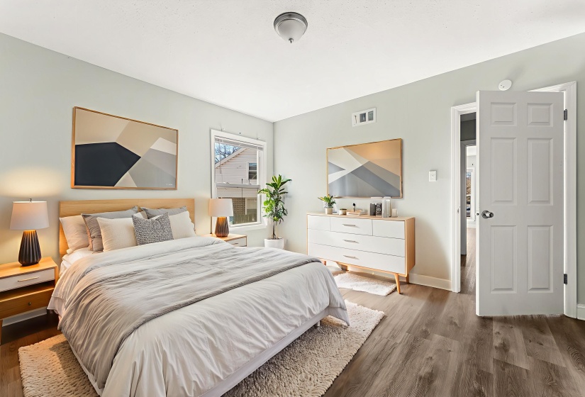 Bedroom featuring wood finished floors and baseboards