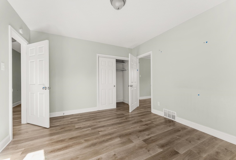 Unfurnished bedroom featuring a closet and wood finished floors