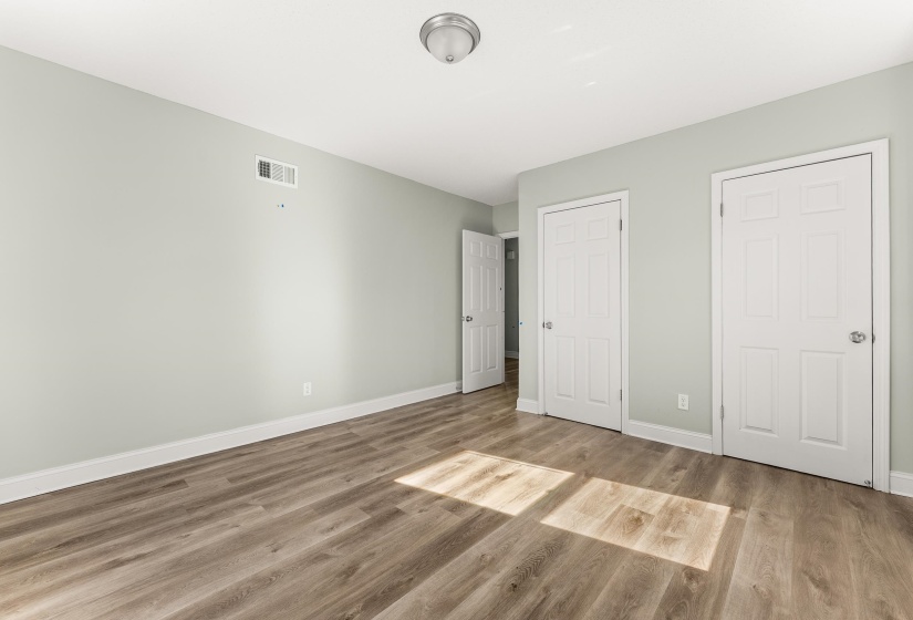 Unfurnished bedroom featuring baseboards and light wood-style floors