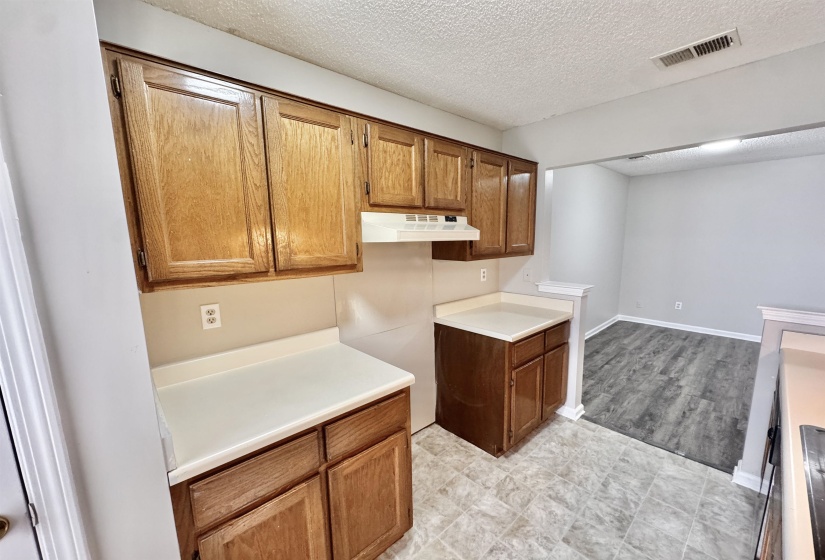 Kitchen featuring wood cabinetry, light countertops, and tile flooring