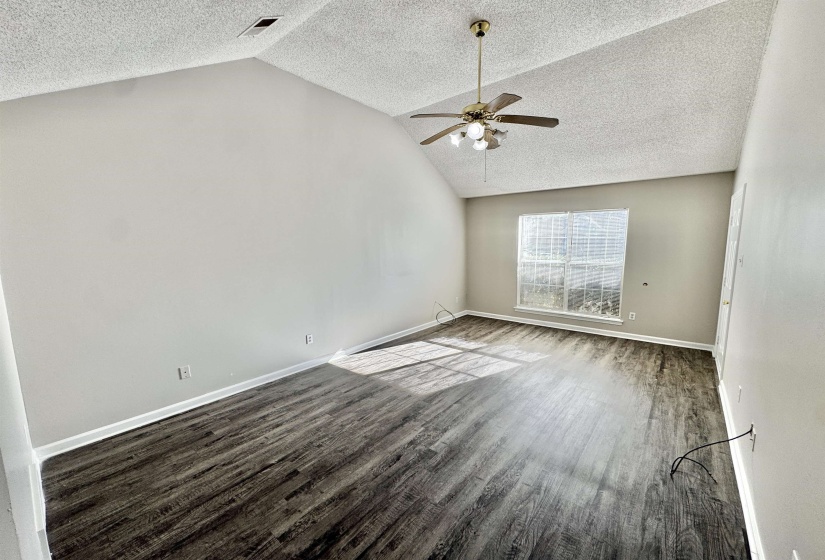Vaulted ceiling featuring a ceiling fan with integrated lighting