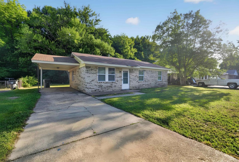 Brick exterior with a covered carport