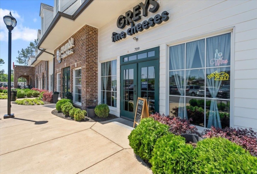 Commercial storefront featuring white siding and brick accents