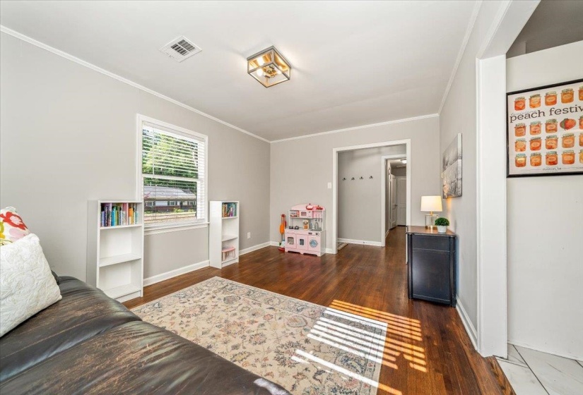 Living area featuring rich wood-finish flooring and light gray wall paint