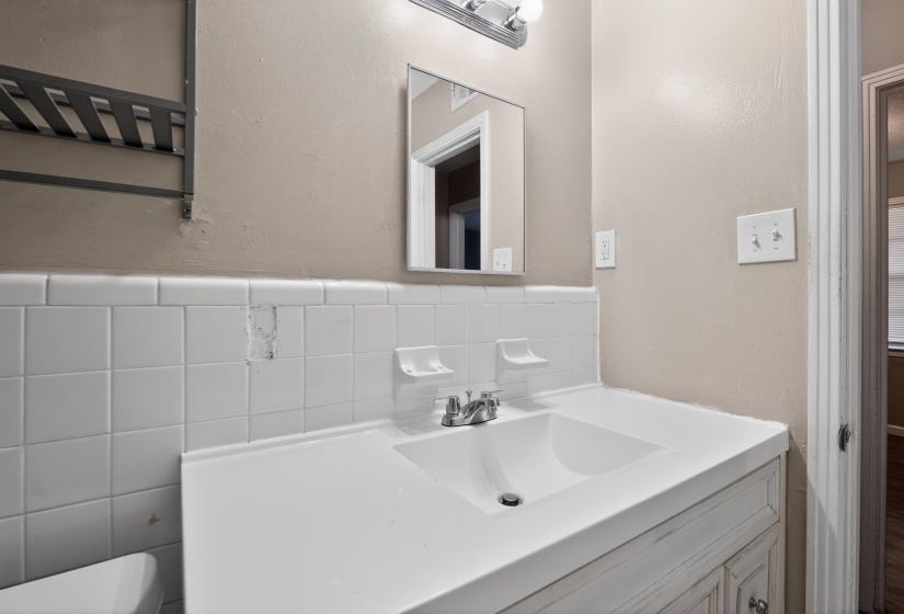 Bathroom vanity with an integrated sink and chrome faucet