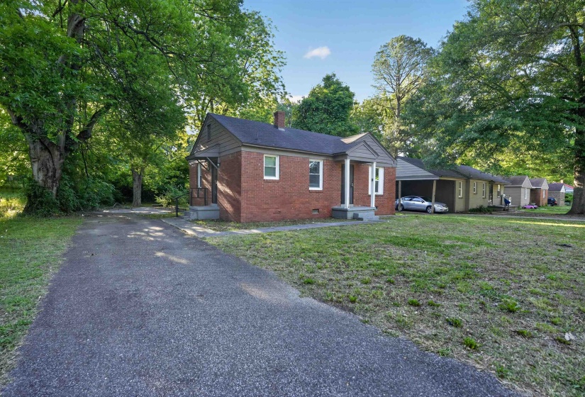 Brick exterior with a covered front porch and a paved driveway