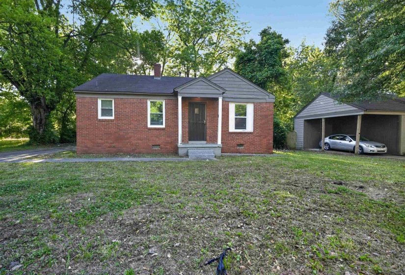 Brick exterior featuring a covered entry