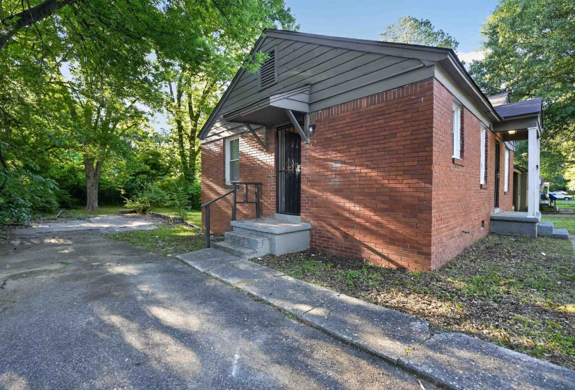 Brick exterior with a gabled roof and covered entry