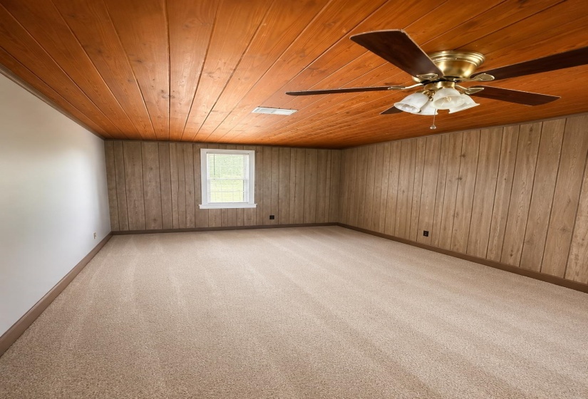 Wood-paneled ceiling with an integrated ceiling fan light fixture
