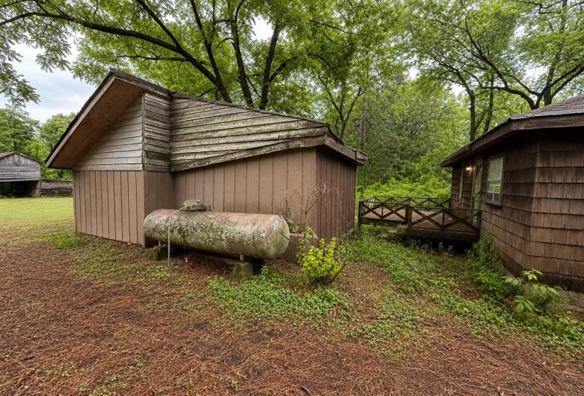 Two distinct structures featuring wood siding and roofing