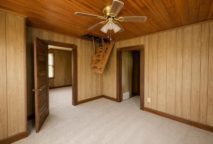 Room featuring wood-paneled walls and a wood-planked ceiling