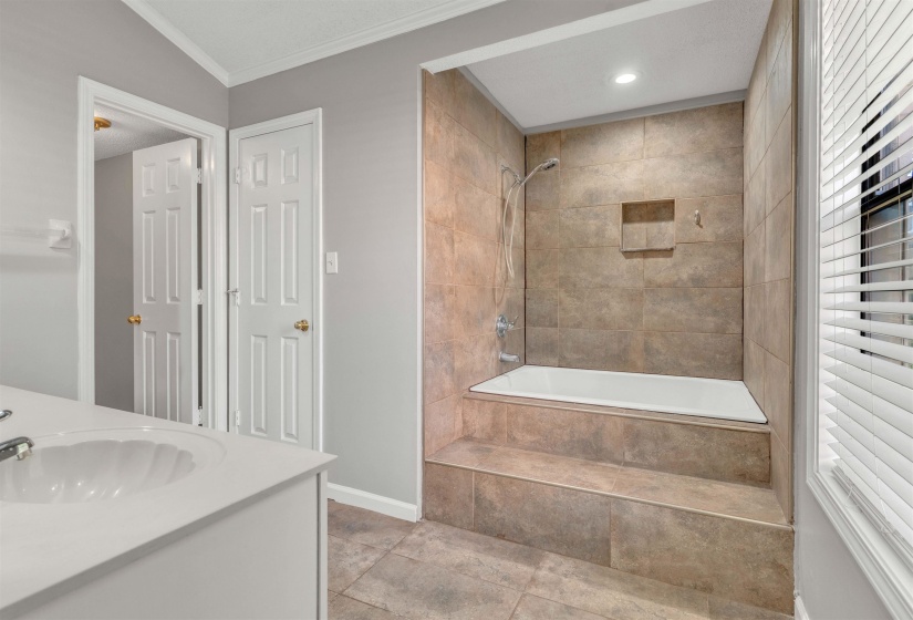 Tiled tub-shower combination with recessed niche and integrated steps