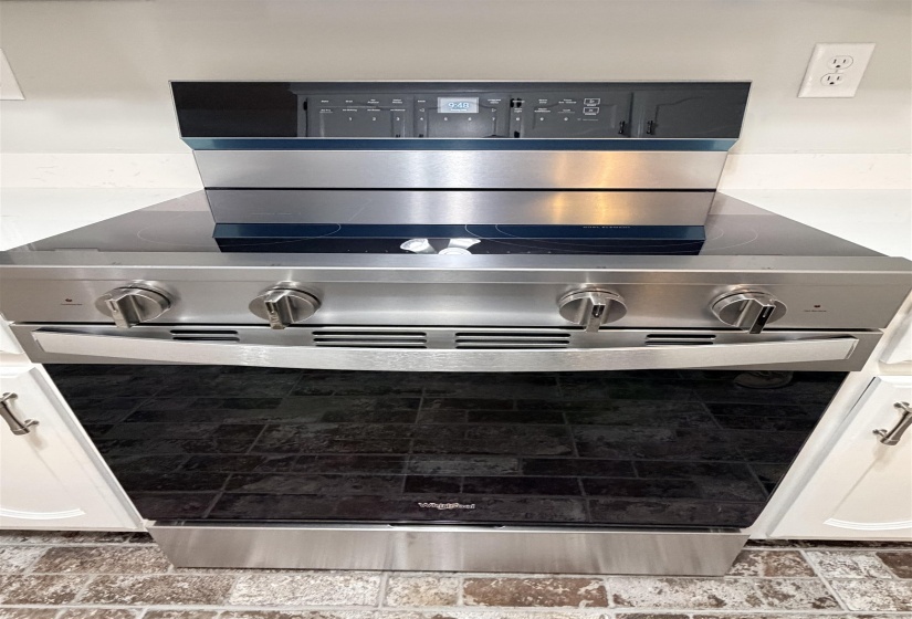 Stainless steel range with a glass cooktop and digital controls
