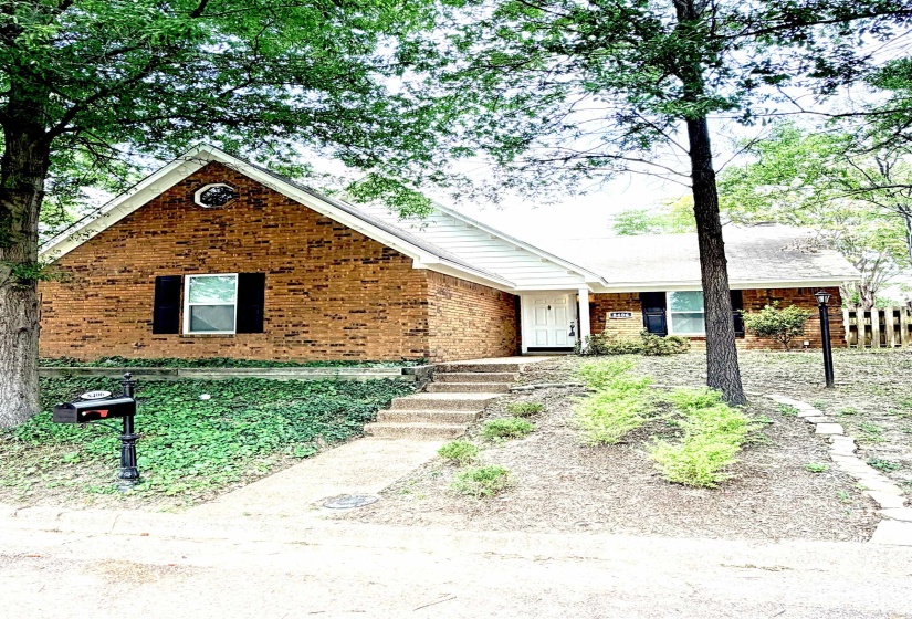 Brick exterior with white trim and a prominent peaked gable