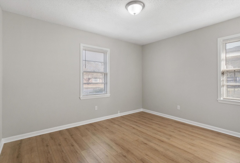Spare room featuring a textured ceiling and light wood finished floors