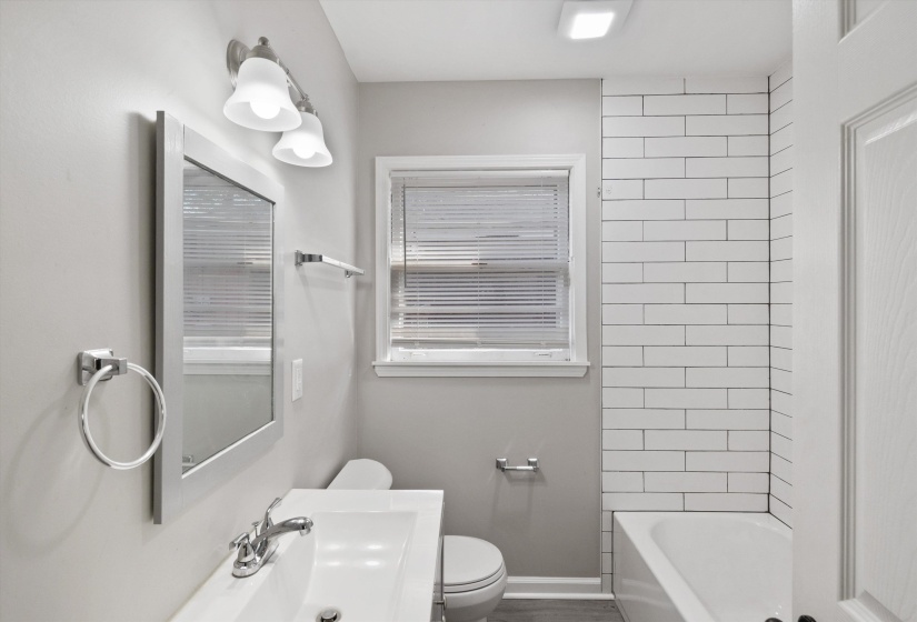 Bathroom with toilet and tub / shower combination
