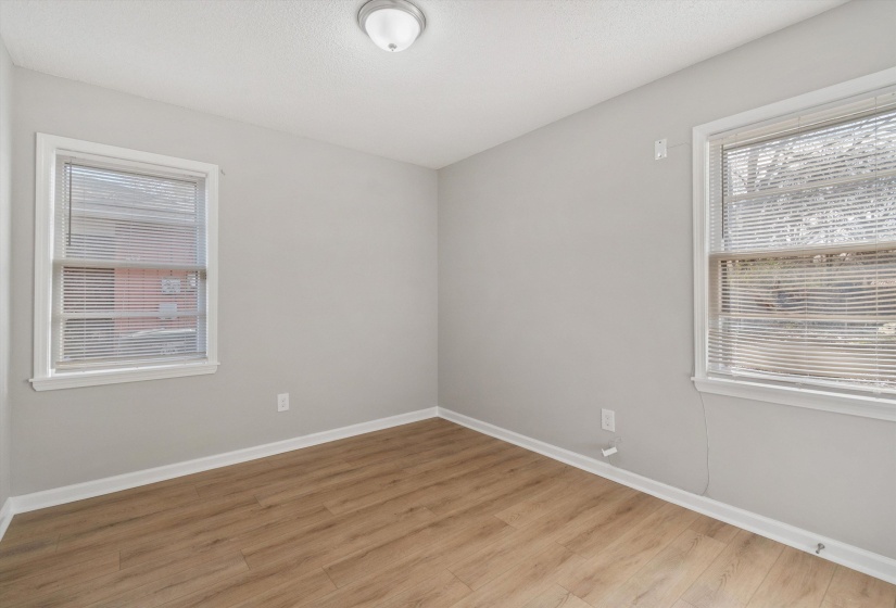 Spare room with light wood-style floors and baseboards