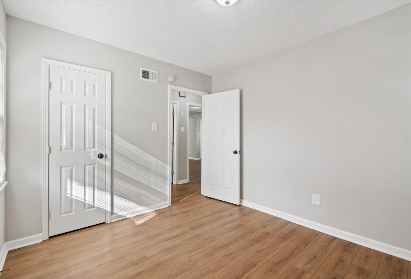 Unfurnished bedroom featuring light wood-style flooring and a textured ceiling