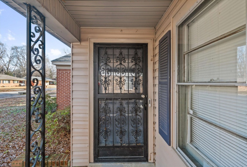 Doorway to property featuring covered porch