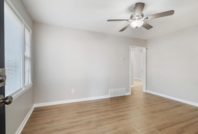Unfurnished room with light wood-style floors and a ceiling fan