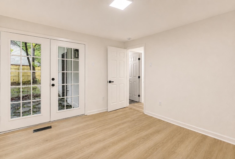 Room featuring light wood-finish flooring, white walls, and a recessed ceiling light