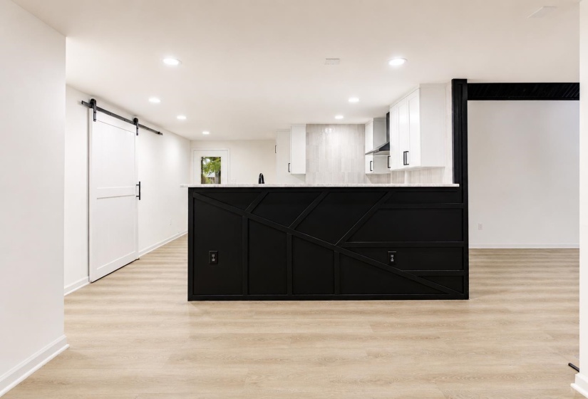 Kitchen island featuring geometric paneling and a light-colored countertop