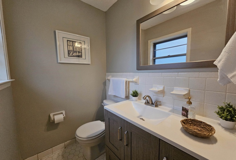 Bathroom with vanity, light tile patterned floors, and tile walls