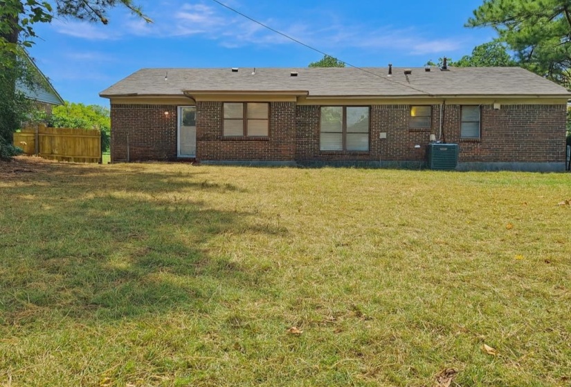 Back of property featuring brick siding