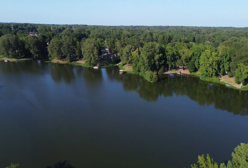 Water view with a heavily wooded area