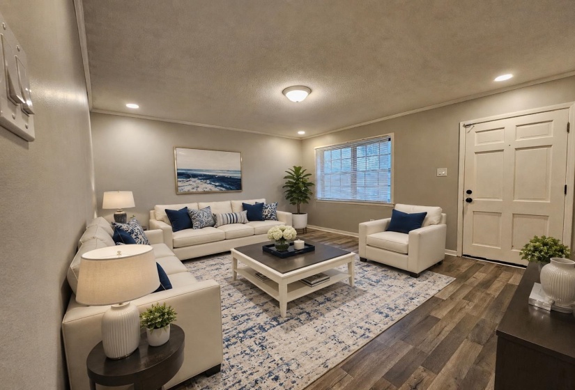 Open living area featuring wood-finish flooring, recessed lighting, and crown molding