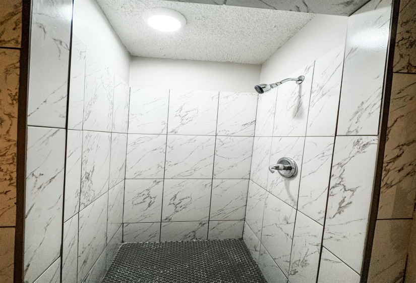 Bathroom featuring a tile shower