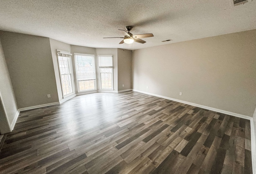Unfurnished room featuring ceiling fan, a textured ceiling, and hardwood / wood-style flooring