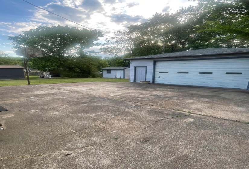 Detached garage featuring panel garage doors and a side entry