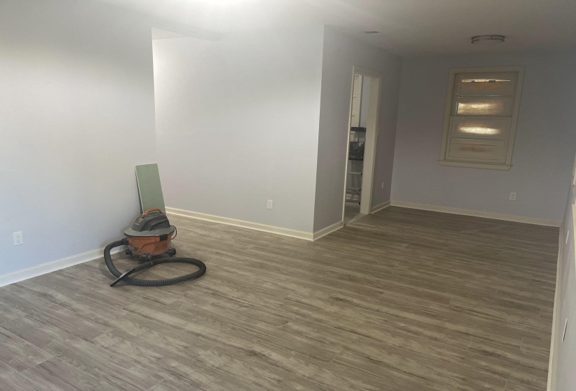 Unfurnished room featuring dark wood finished floors and baseboards
