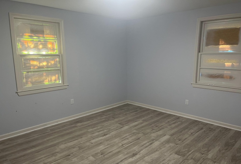 Spare room featuring wood finished floors and baseboards
