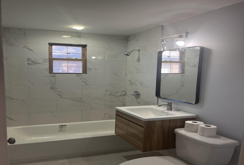 Full bath featuring vanity, shower / bath combination, and healthy amount of natural light