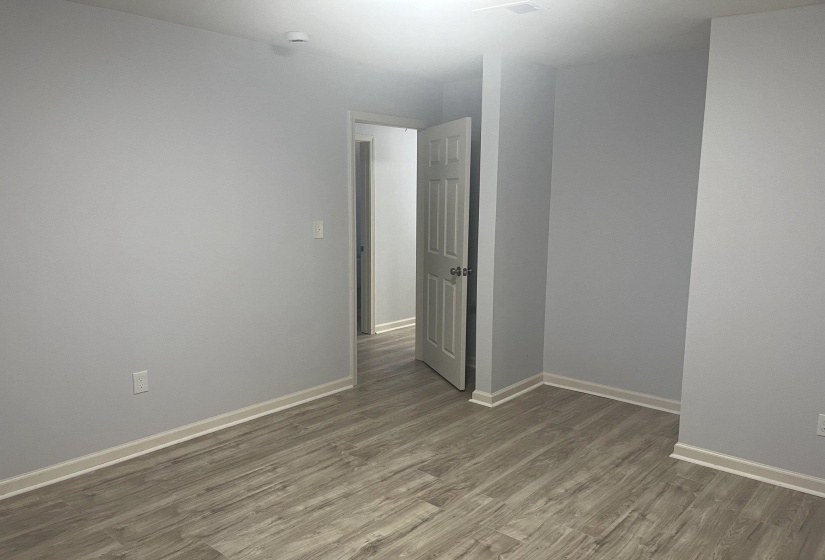 Unfurnished room with light wood finished floors and baseboards