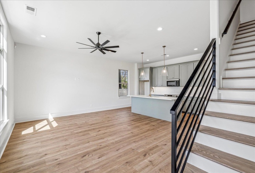 Unfurnished living room featuring light wood-style flooring, recessed lighting, and a ceiling fan