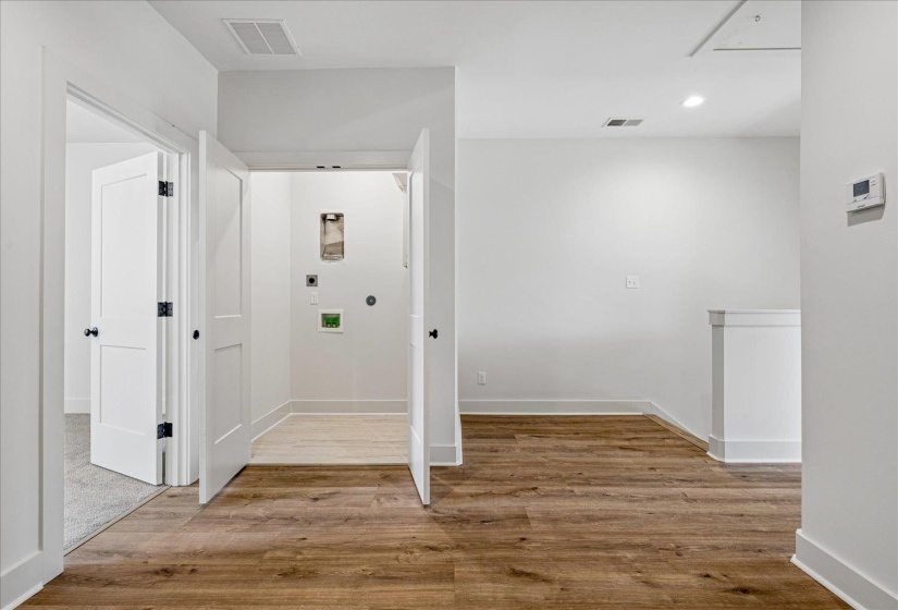 Corridor featuring light wood finished floors and recessed lighting