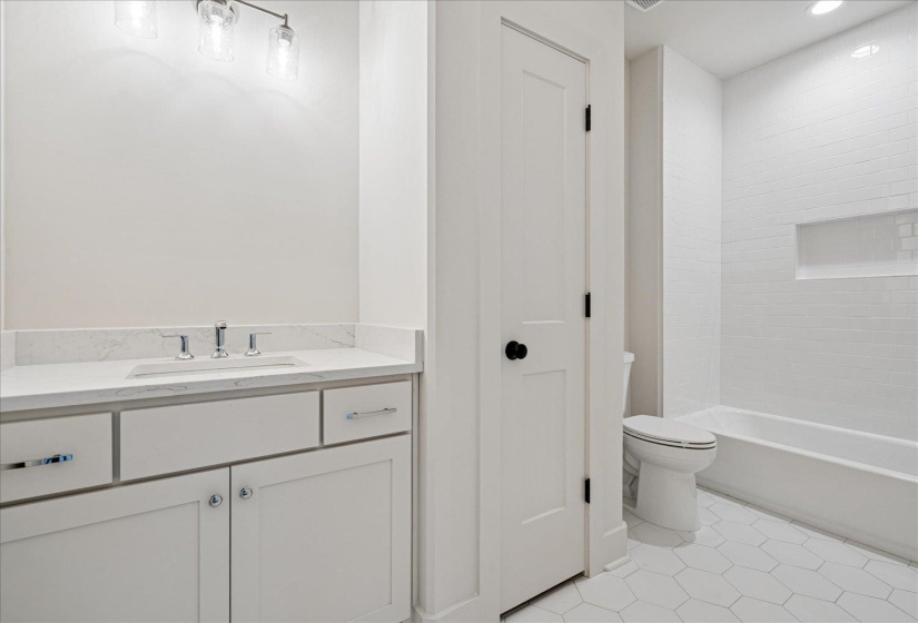 Bathroom with vanity, light tile patterned floors, bathtub / shower combination, and recessed lighting