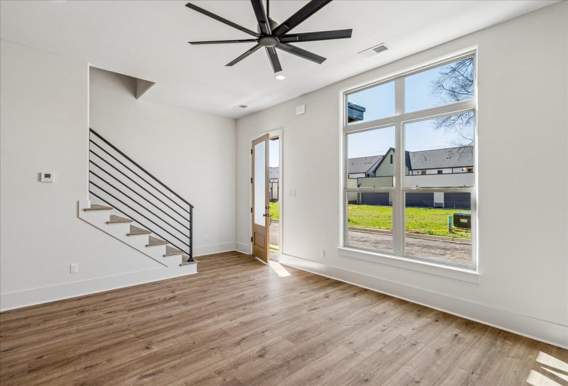Unfurnished living room with light wood-style flooring and ceiling fan