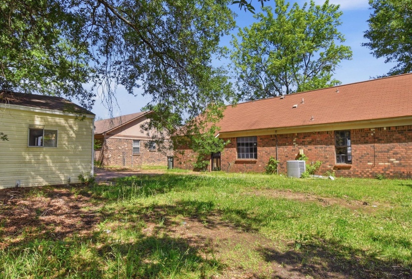 Expansive grassy yard with mature trees
