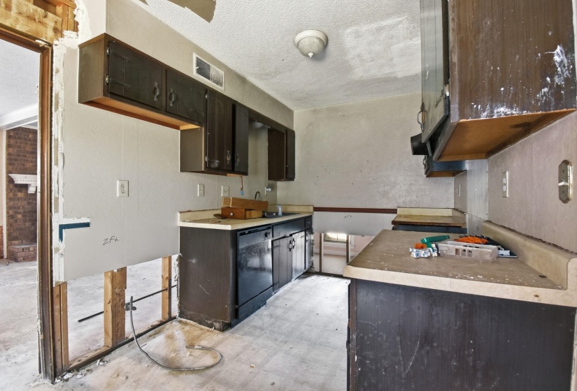 Kitchen space with dark wood cabinets and light countertops