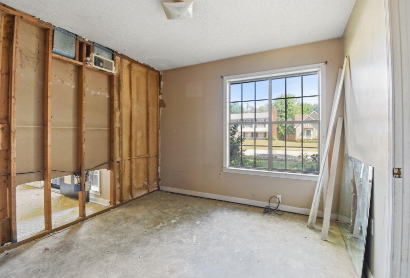 Room featuring exposed wall studs and subflooring, providing a blank canvas for customization